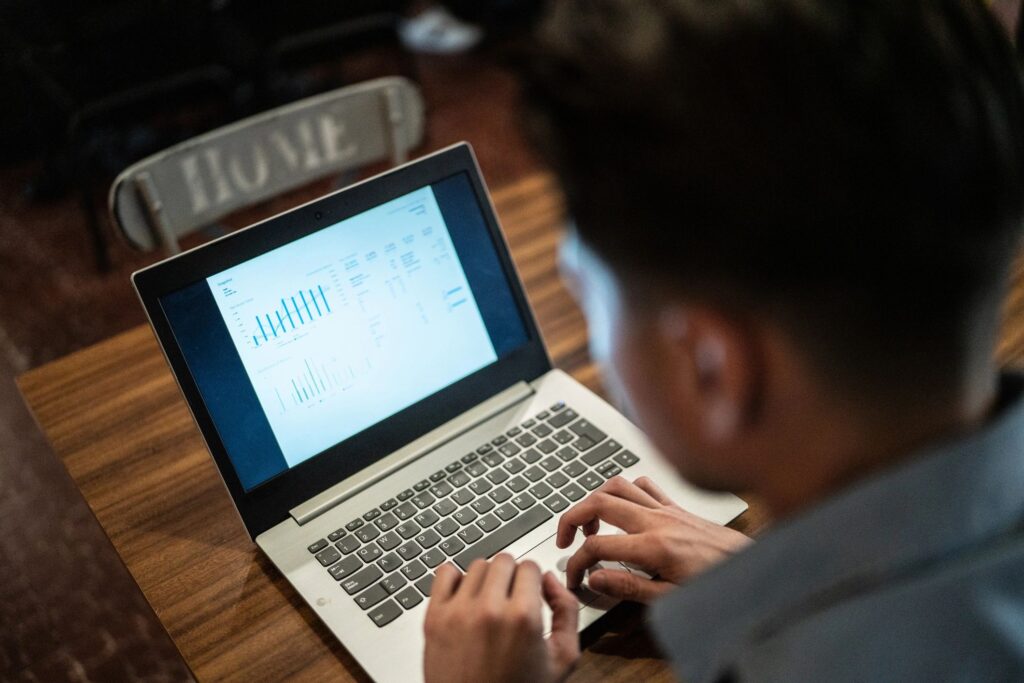 Businessman using laptop looking for investments in a restaurant