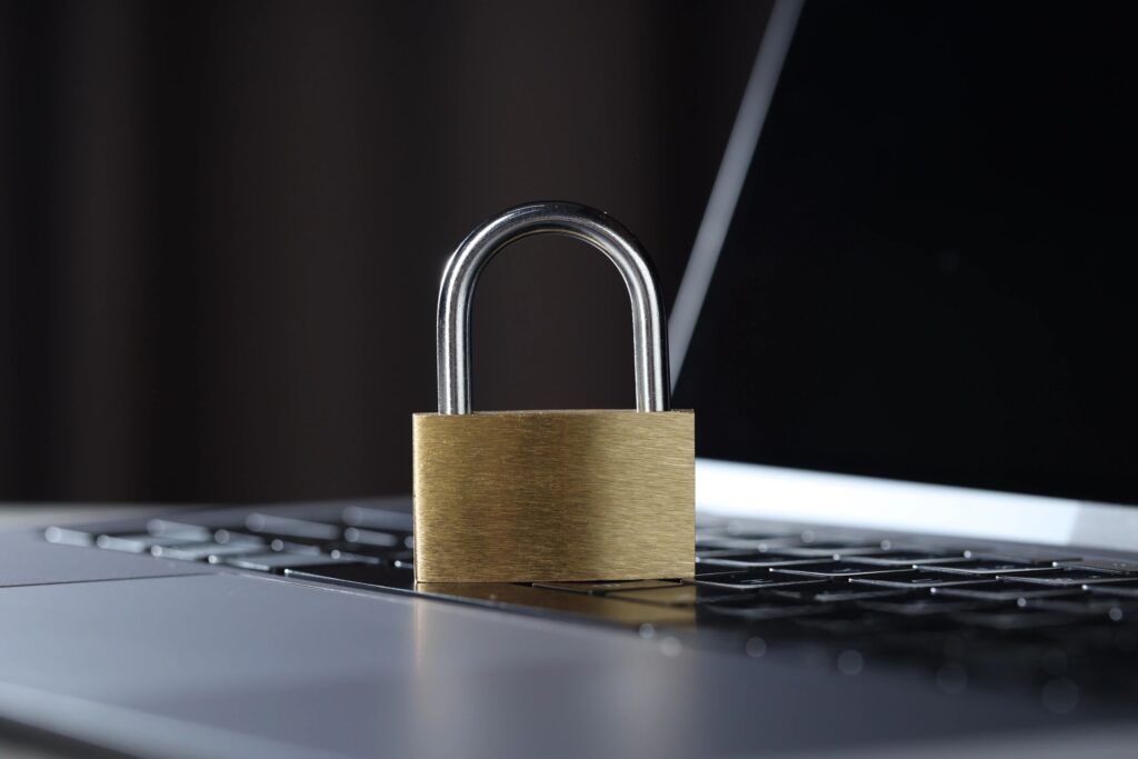 Cyber safety. Metal padlock on laptop, closeup