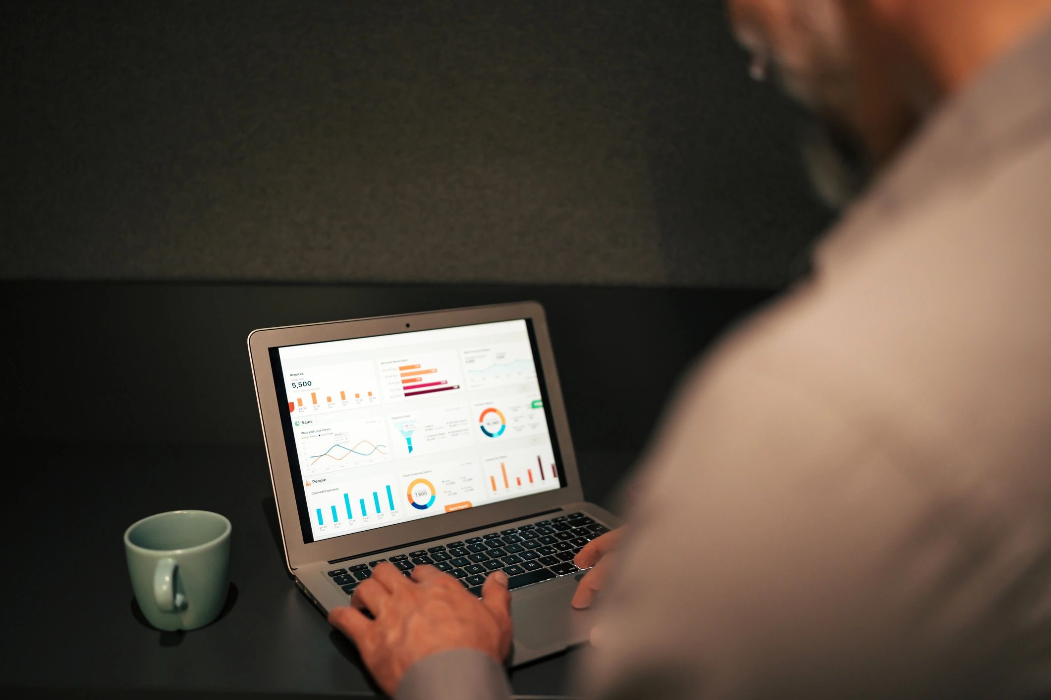 Professional reviewing data on a laptop