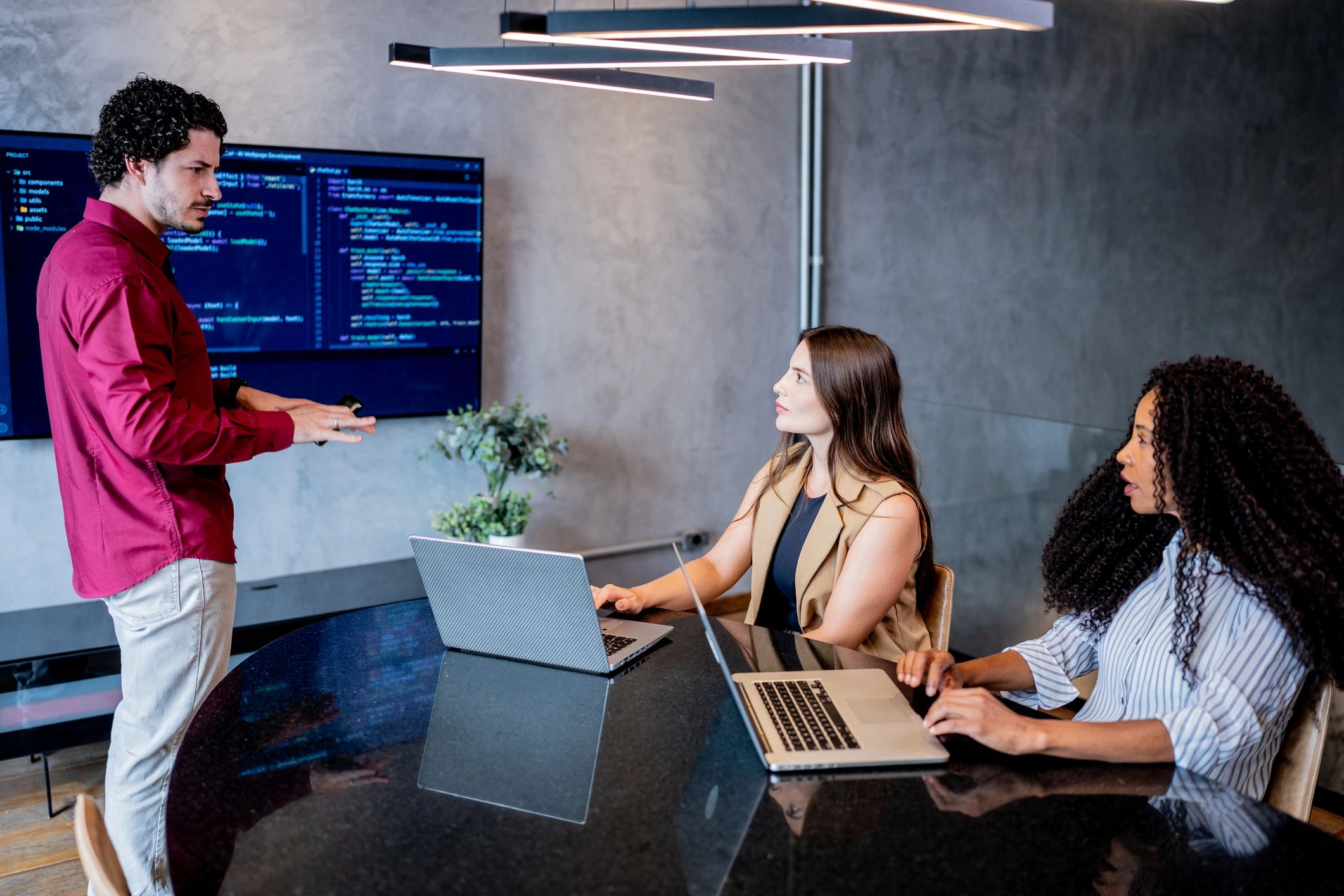 Team reviewing laptop in an office