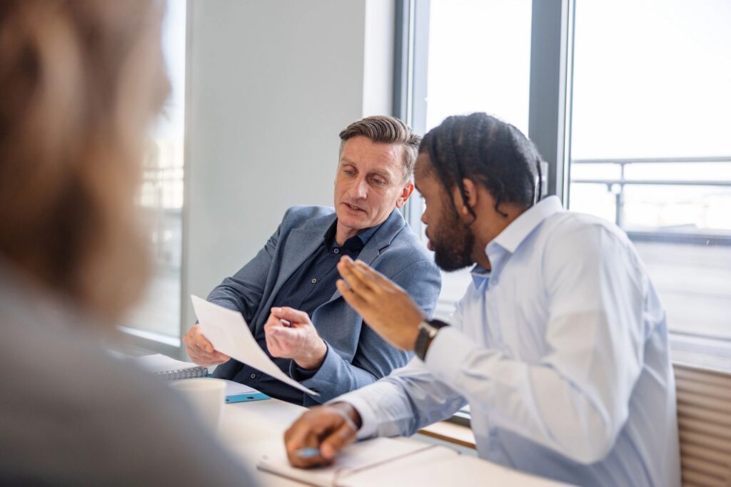 Two Male Coworkers Sharing Their Opinions In The Conference Room
